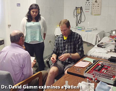 Dr. David Gamm examines a patient