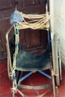 This ragged wheelchair was replaced by a new custom-fitted one by the Wisconsin/Nicaragua Wheelchair Project.