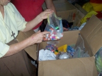 Sister Sandy opens newly arrived school supplies.